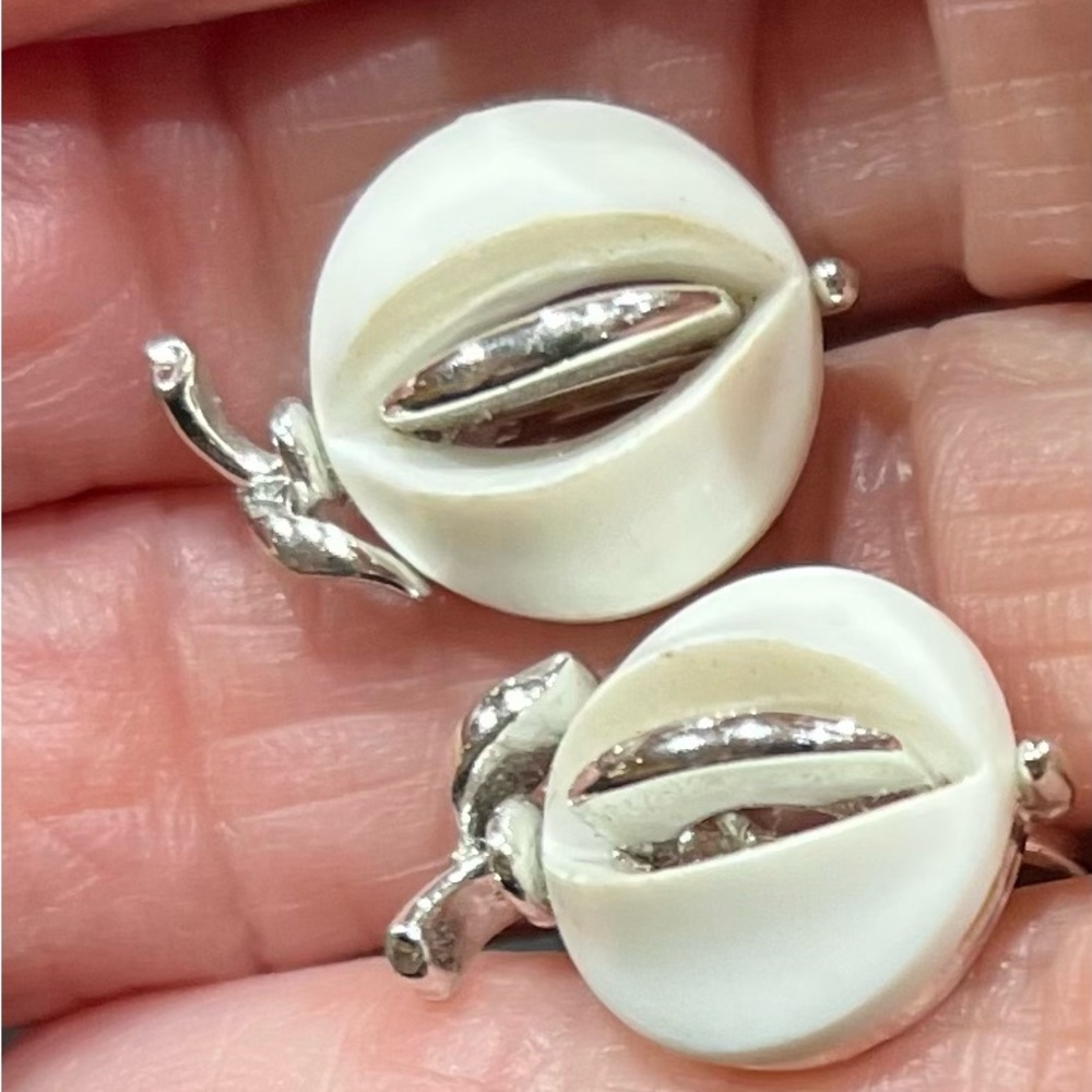 White and silver earrings. Screw